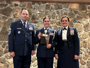 Abigael Nievar receives the 2023 Air Force Sergeants Association Non-Commissioned Officer of the Year Award from Chief Master Sgt. Todd H. Parsons, Civil Air Patrols National Command Chief, and Chief Jessica Settle, Command Chief of Missouri Air National Guard. 